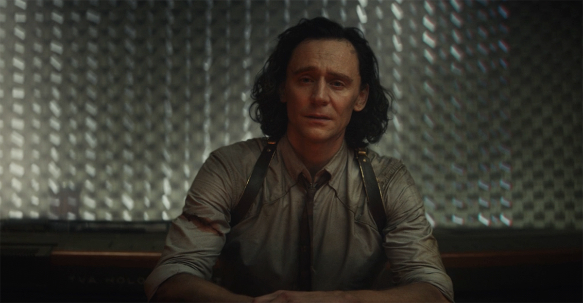 Loki, defeated, crying in a dark room