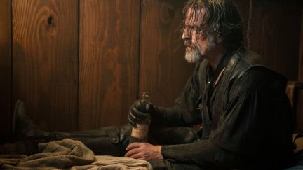 A disheveled man holds a bottle of alcohol in 'Our Flag Means Death.'