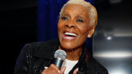 Dionne Warwick holds a microphone