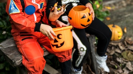 Kids in costumes with buckets of candy on Halloween