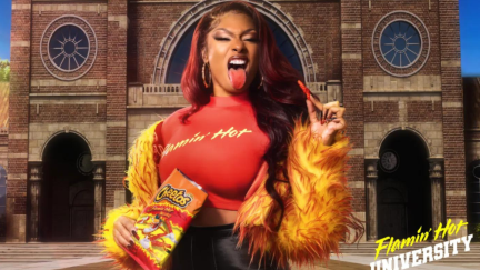 Meg Thee Stallion holding a bag of Flamin' Hot Cheetos