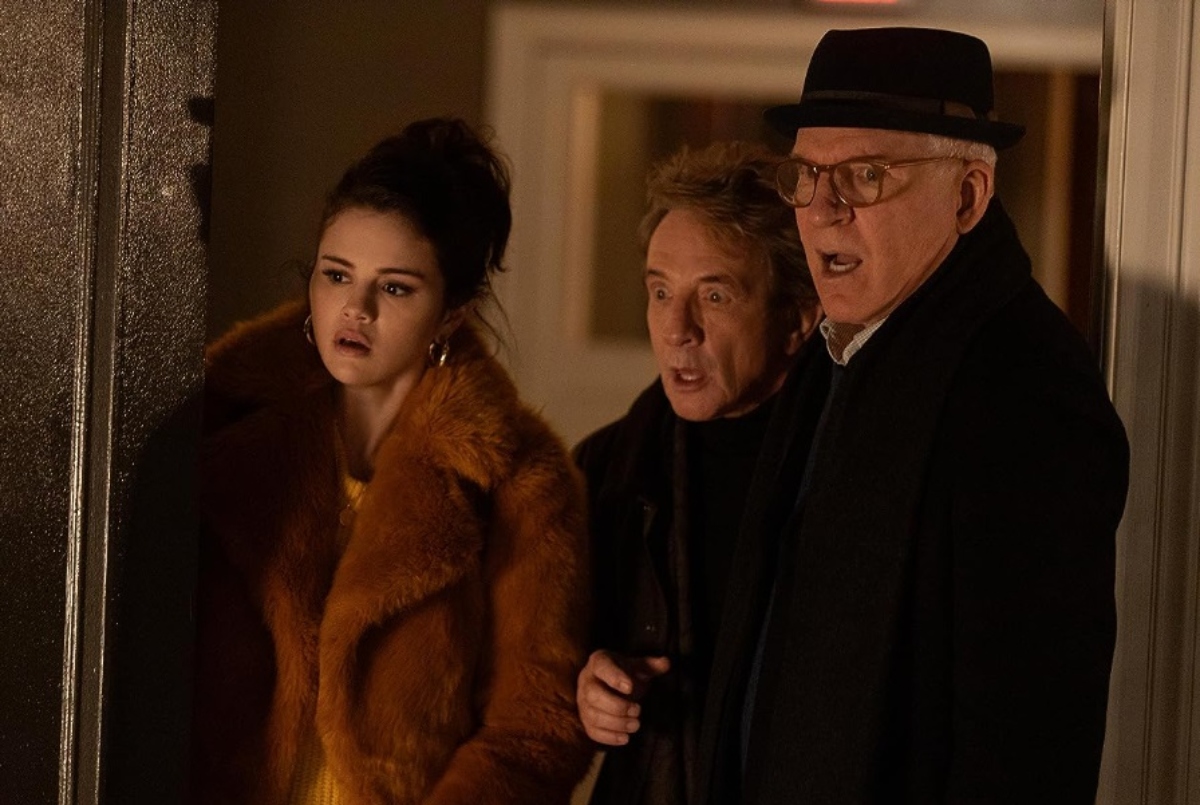 Only Murders In The Building castmates Selena Gomez, Martin Short, and Steve Martin look shocked at something off-camera.