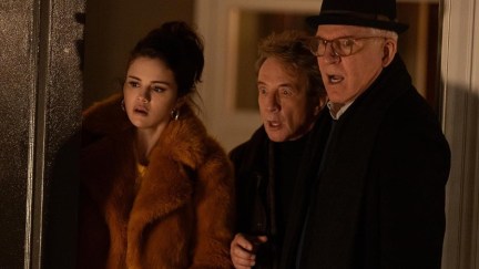 Only Murders In The Building castmates Selena Gomez, Martin Short, and Steve Martin look shocked at something off-camera.