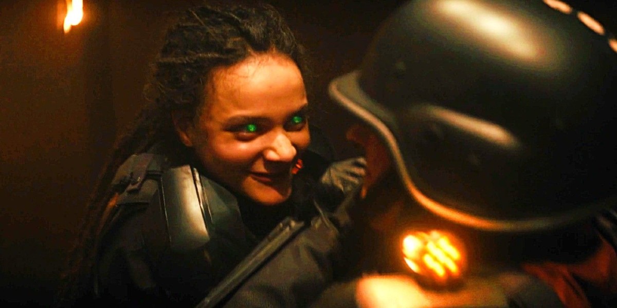 A woman with glowing eyes attacks a man wearing a helmet in 'Loki'.