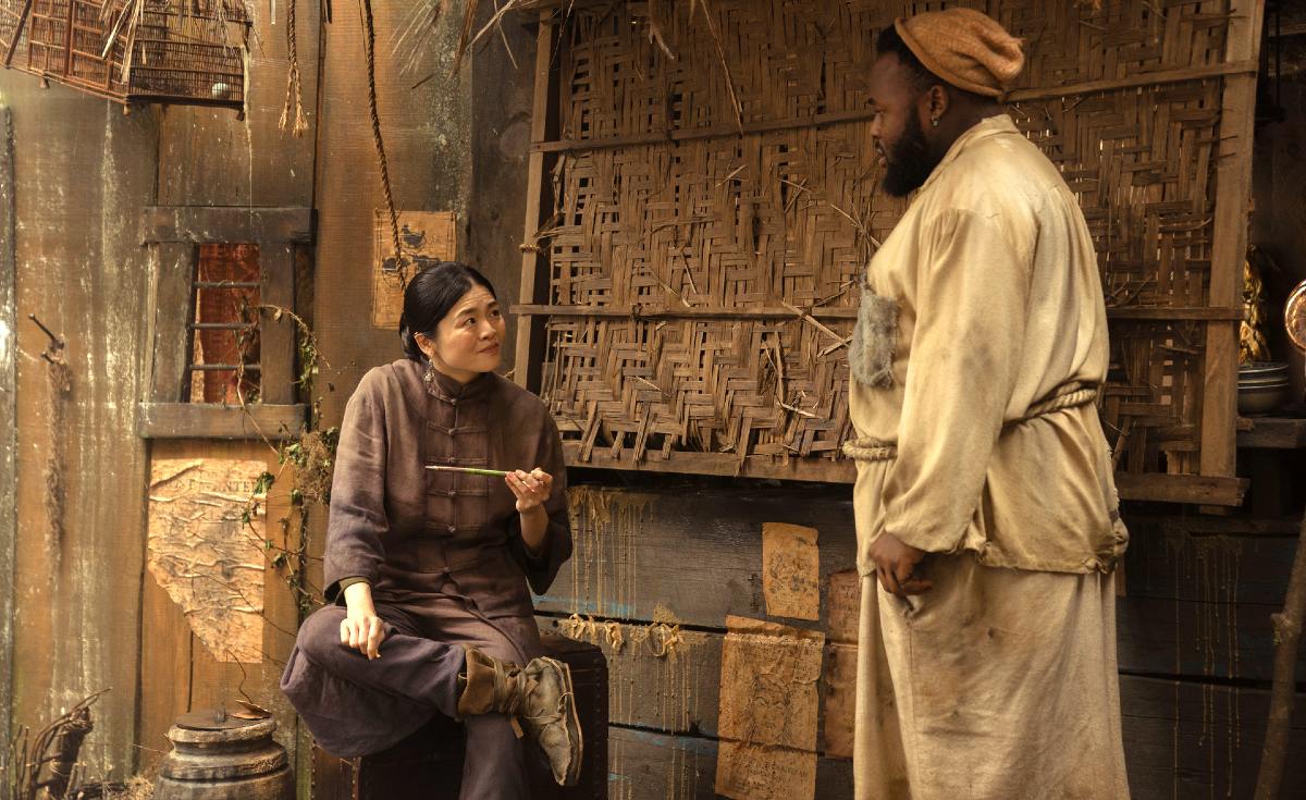 Standing outside of a soup stand, a man and woman talk in 'Our Flag Means Death.'