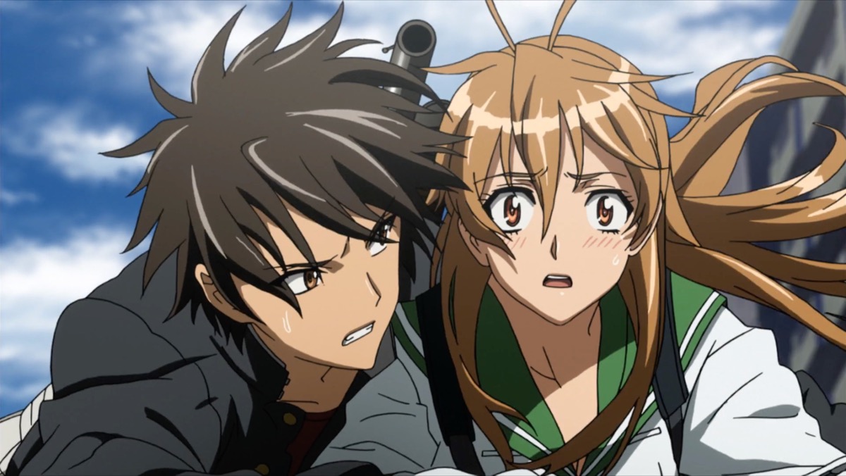 A highschool girl stares with a shocked look on her face while a boy holds on to her in "High School of the Dead