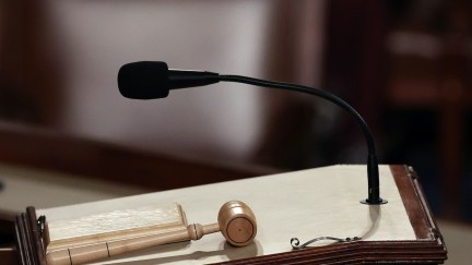 A closeup on the House Speaker's podium, with a gavel resting on it.