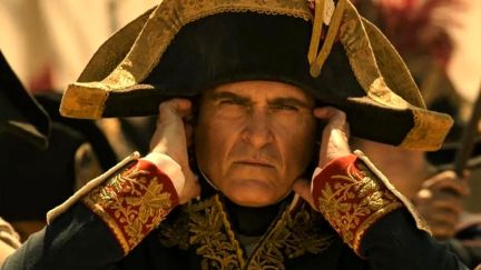 French Emperor Napoleon Bonaparte (Joaquin Phoenix) covering his ears.