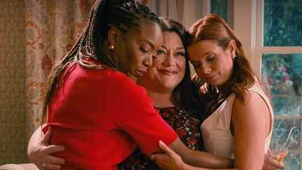 Heather Hadley as Helen, JoAnna Garcia Swisher as Maddie, and Brooke Elliot as Dana Sue in a group hug in Sweet Magnolias season 3.