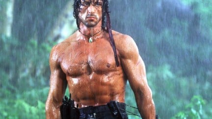 Sylvester Stallone in Rambo First Blood Part II, standing in the rain in the jungle.