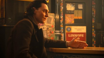 Loki sits at a bar, talking to Sylvie, who's off camera.