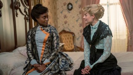 Peggy Scott and Marian Brook sit on a bed talking in 'The Gilded Age' season 2.