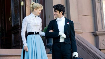 Marian Brook and Larry Russell stand outside a house in 'The Gilded Age.'