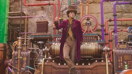 Timothée Chalamet as Willy Wonka standing in his building chocolate factory