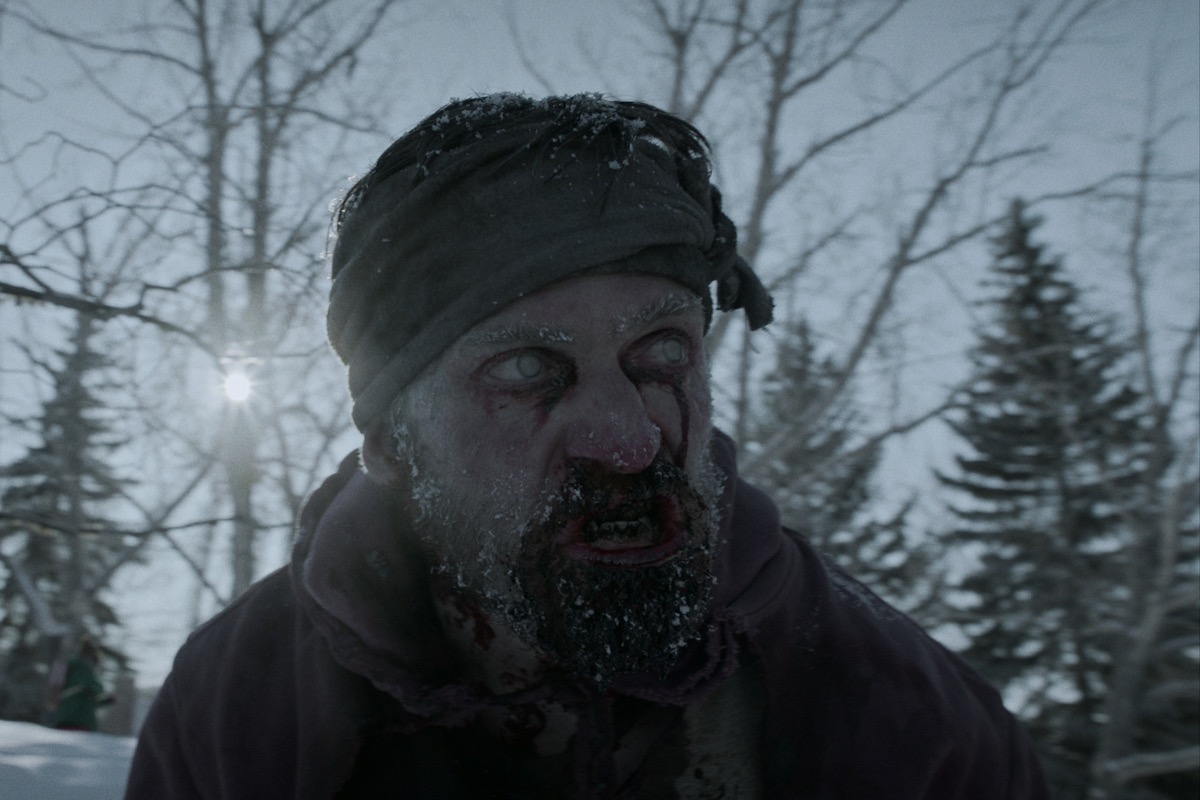 A zombie stares in the snow in "Black Summer"