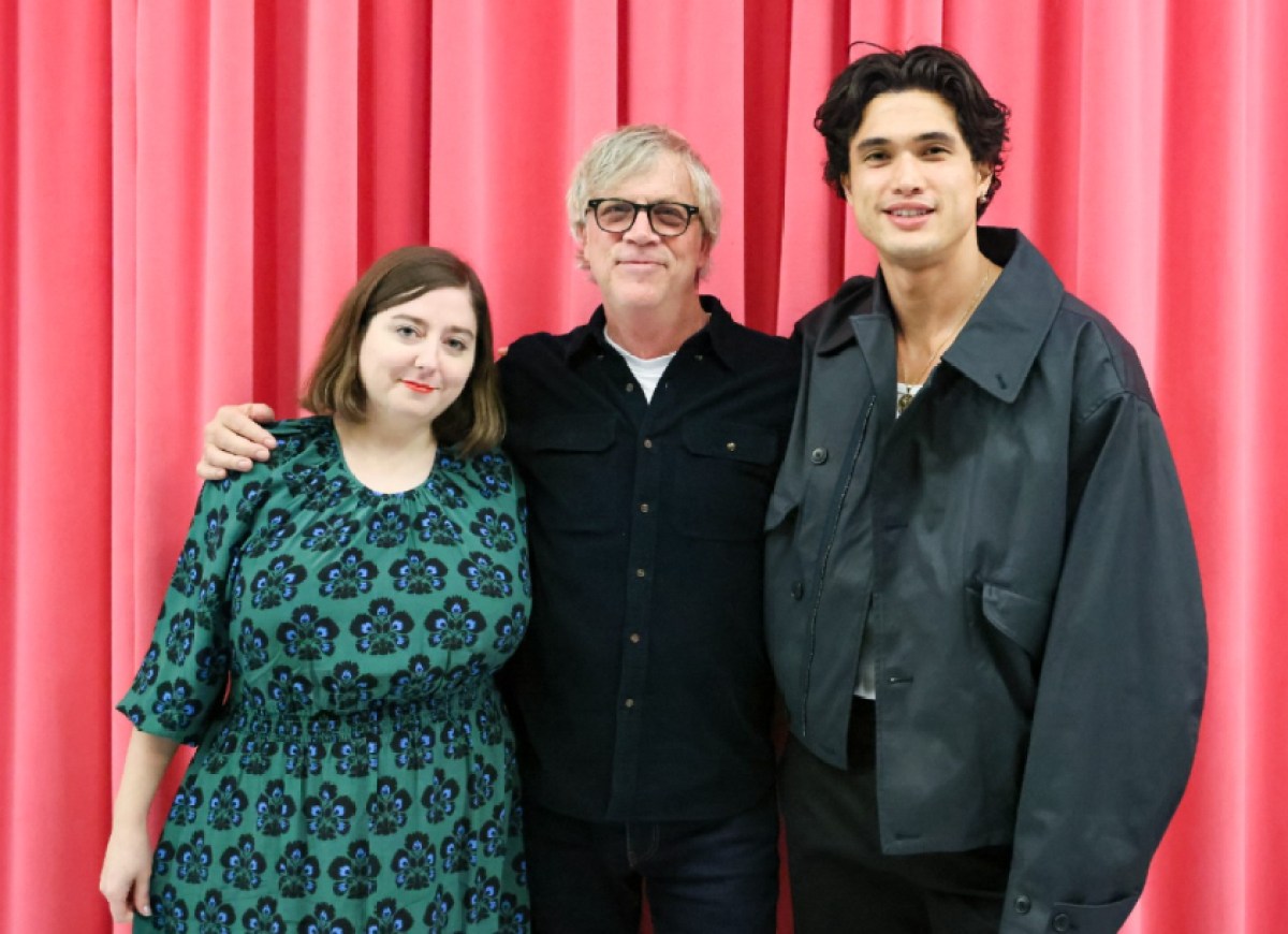 'May December' screenwriter Samy Burch stands next to director Todd Haynes and actor Charles Melton on the red carpet.