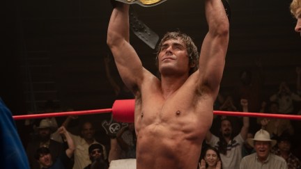 Zac Efron holding up the belt in the Iron Claw