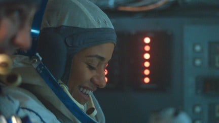 Ariana DeBose as Kira Foster, wearing a pressure suit in I.S.S.