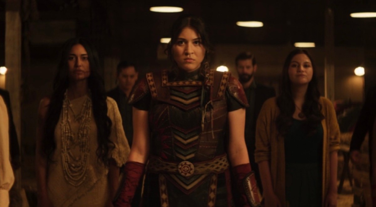 Maya, dressed in the outfit Chula made her, stands with her ancestors flanking her.