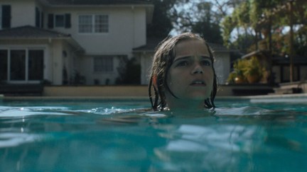 Elliot Waller (Gavin Warren), a little boy, swims in a pool in 'Night Swim'.