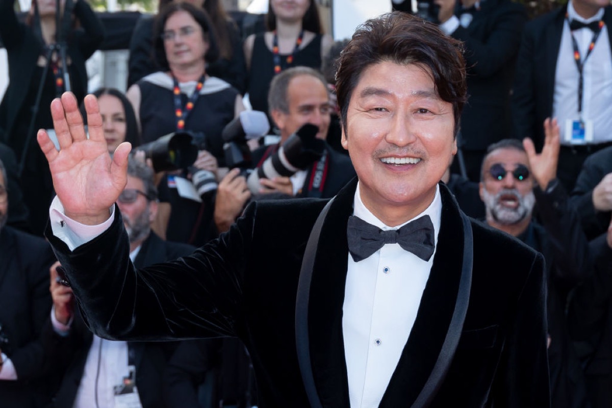 Song Kang-ho waves to   the camera at Cannes.