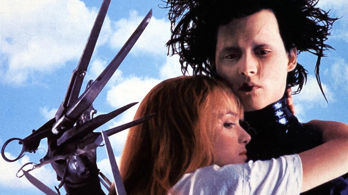 Johnny Depp as Edward Scissorhands with Kim Boggs (Winona Ryder) clinging to his chest