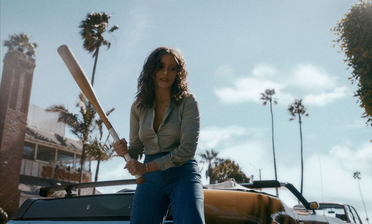 Sofia Vergara as Griselda Blanco, beating a man who stole her product with a baseball bat from Netflix series Griselda.