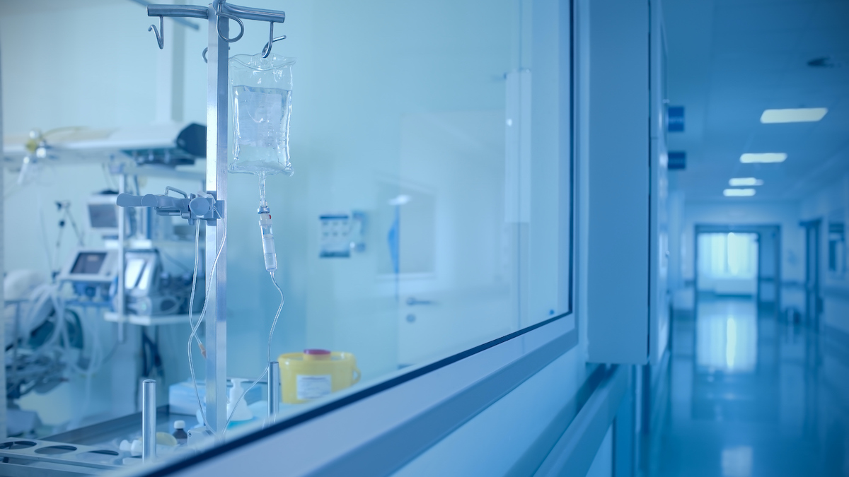 Empty hospital room and corridor in blue light.