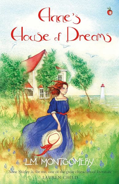 Cover of L. M. Montgomery's Anne's House of Dreams. A watercolour painting style cover with a chestnut haired woman in a blue dress, carrying a hat, stood in front of a white house with trees.