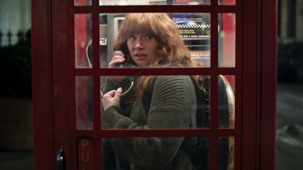 Bryce Dallas Howard on the phone in a phone booth with her cat in Argylle