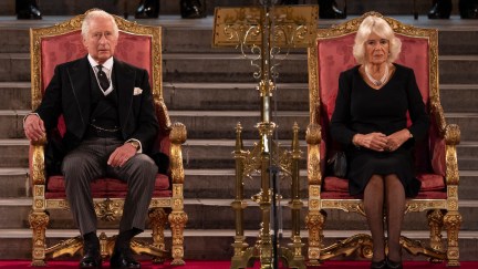 King Charles III and Camilla, Queen Consort sit on thrones.