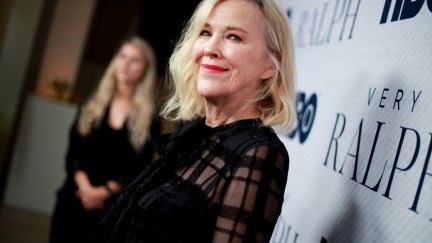 Catherine O'Hara wears a black dress on the red carpet.