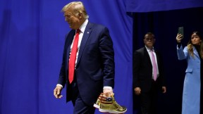 Donald Trump appears at Sneaker Con to sell his gold sneakers.