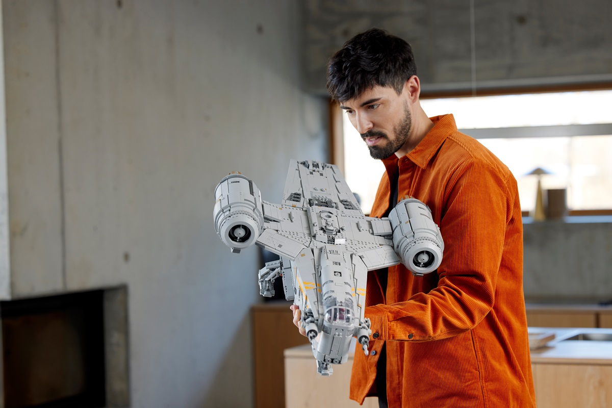 man holding a LEGO Star Wars The Razor Crest™