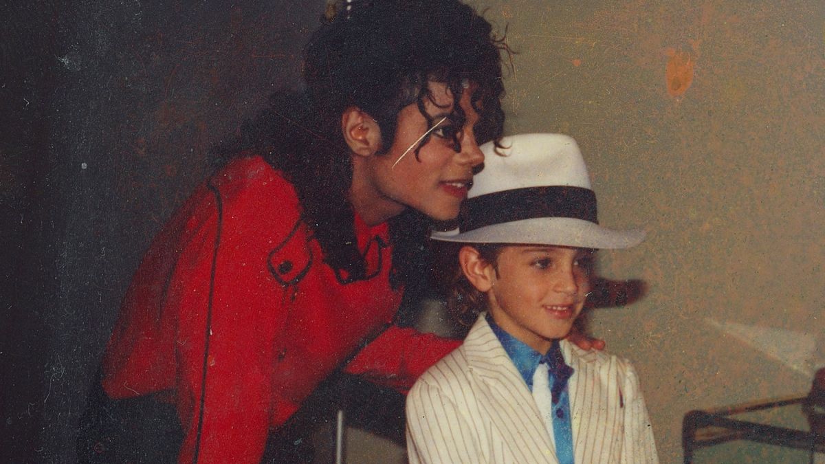 Michael Jackson and a child wearing a white hat