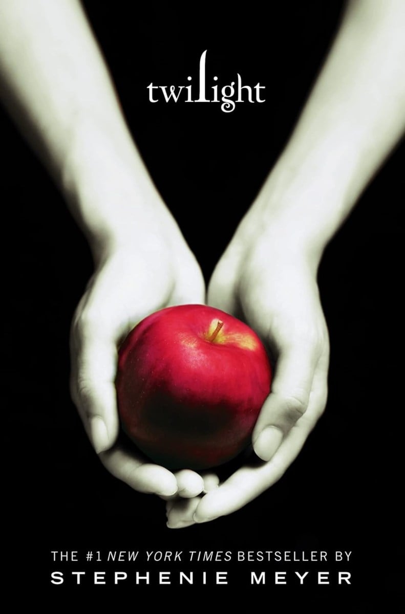 white hands holding a red apple