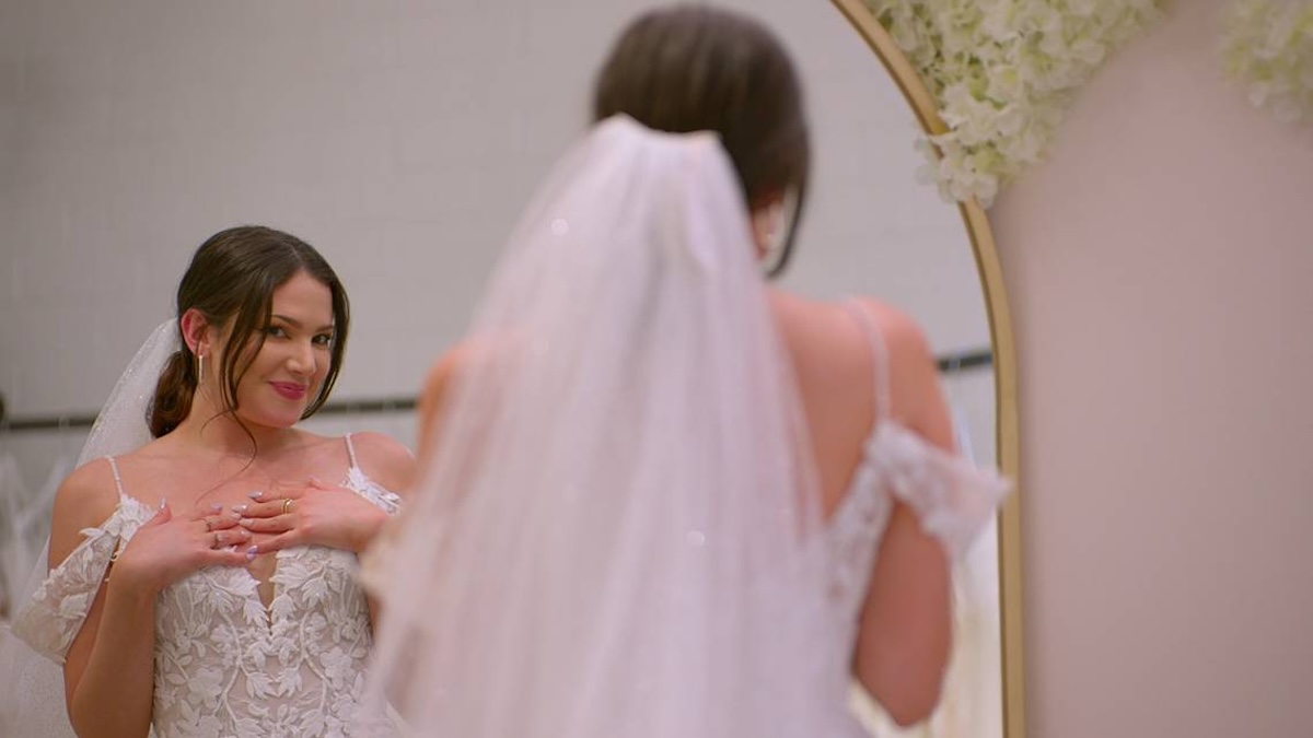 amy standing in a mirror in her wedding dress in love is blind