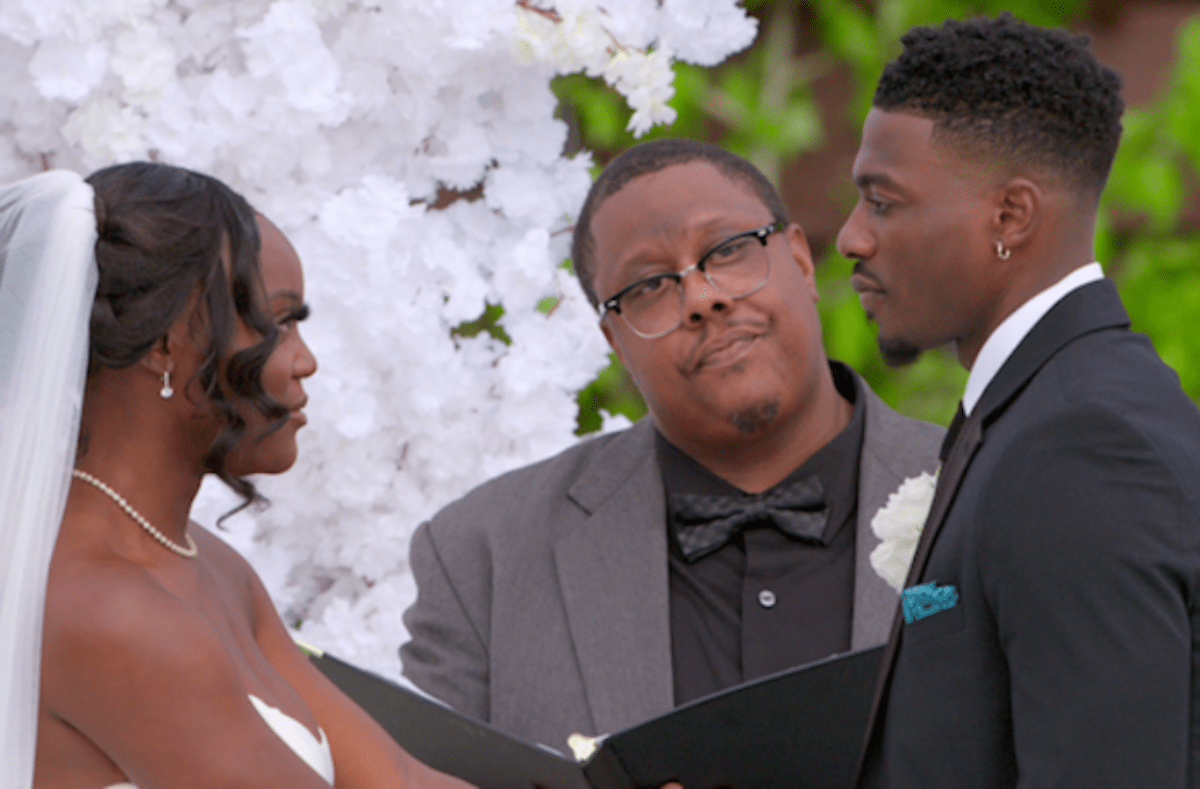 Clay and AD standing at the altar exchanging vows