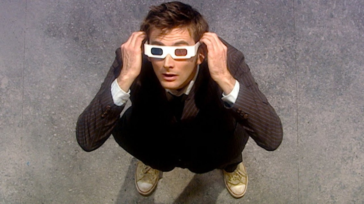 David Tennant looks up at the sky wearing 3D glasses in Doctor Who