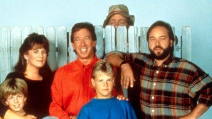 the cast of home improvement standing in front of a fence