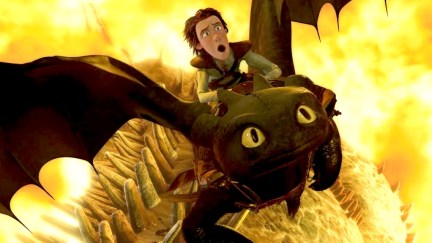 A boy rides a dragon through fire in 