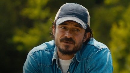 Orlando Bloom talking while wearing a baseball cap