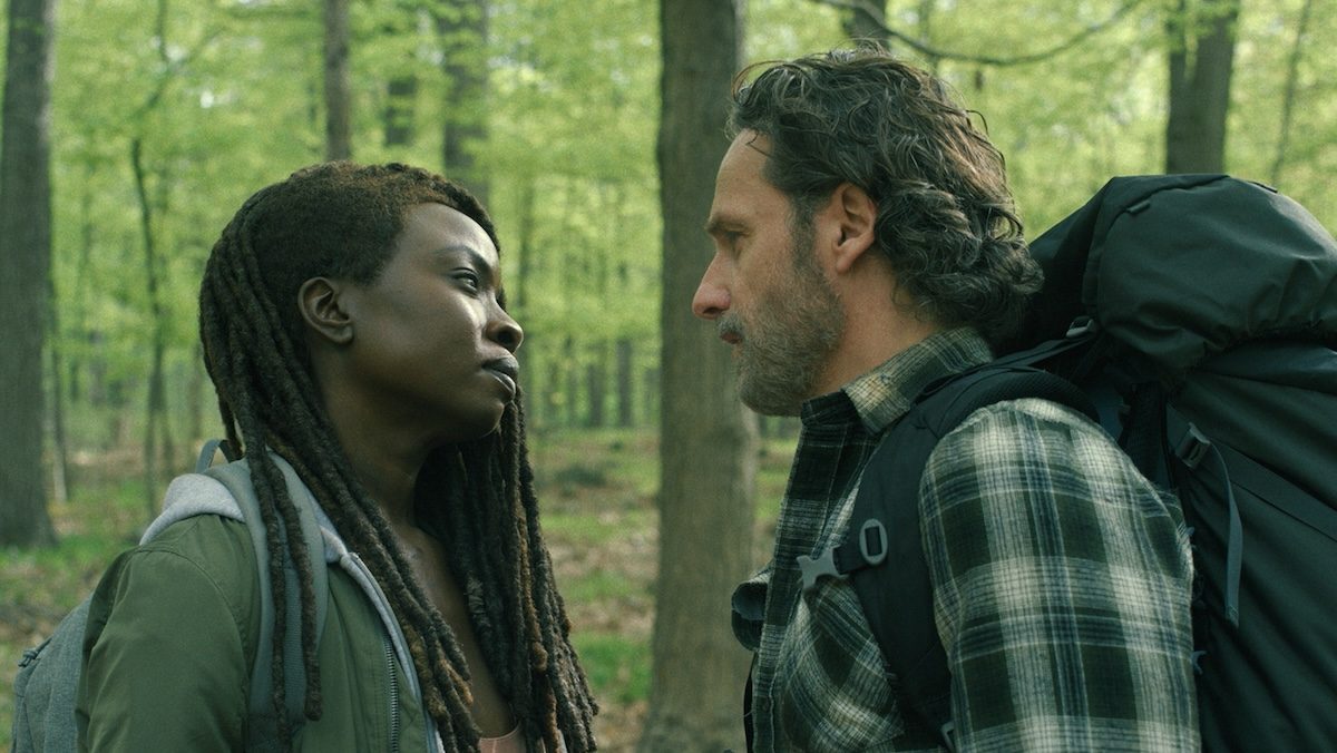 Rick and Michonne standing in the woods with each other