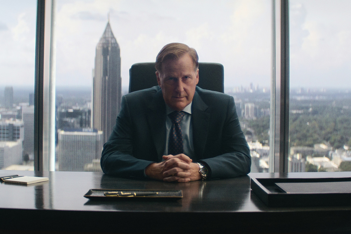 Jeff Daniels sits at a desk in A Man In Full