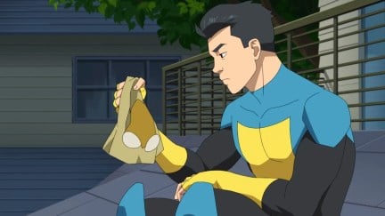 Mark Grayson looks at his mask in Invincible season 2