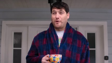 adam pally as wade whipple standing with a coffee mug