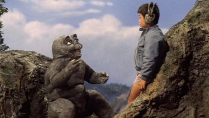 Baby monster Minilla talks to a little boy in 