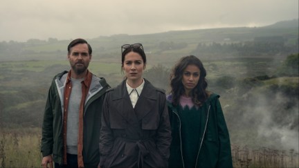 (L to R) Will Forte as Gilbert Power, Siobhán Cullen as Dove, Robyn Cara as Emmy Sizergh in episode 102 of Bodkin. Three people stare straight ahead.