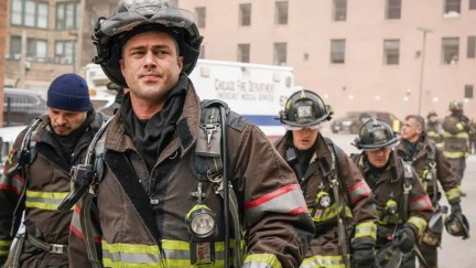 The cast of Chicago Fire all standing in their firefighter gear