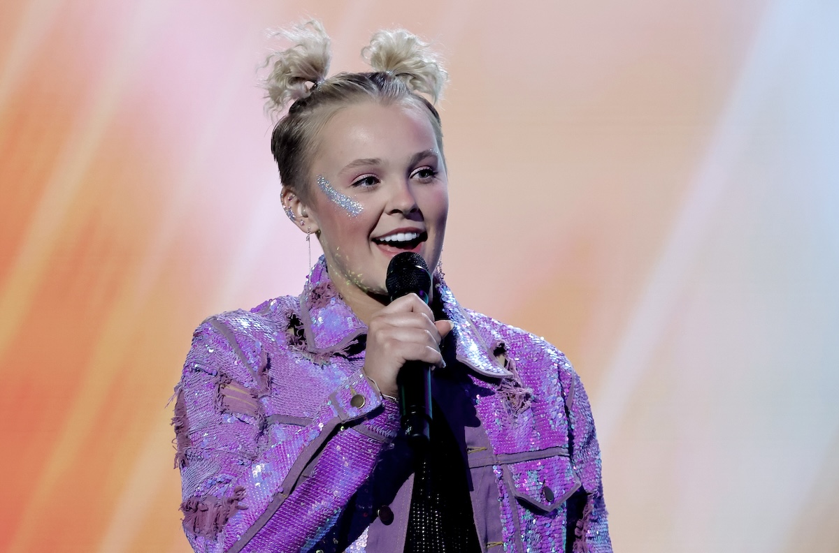 JoJo Siwa with a mic in her hand on stage